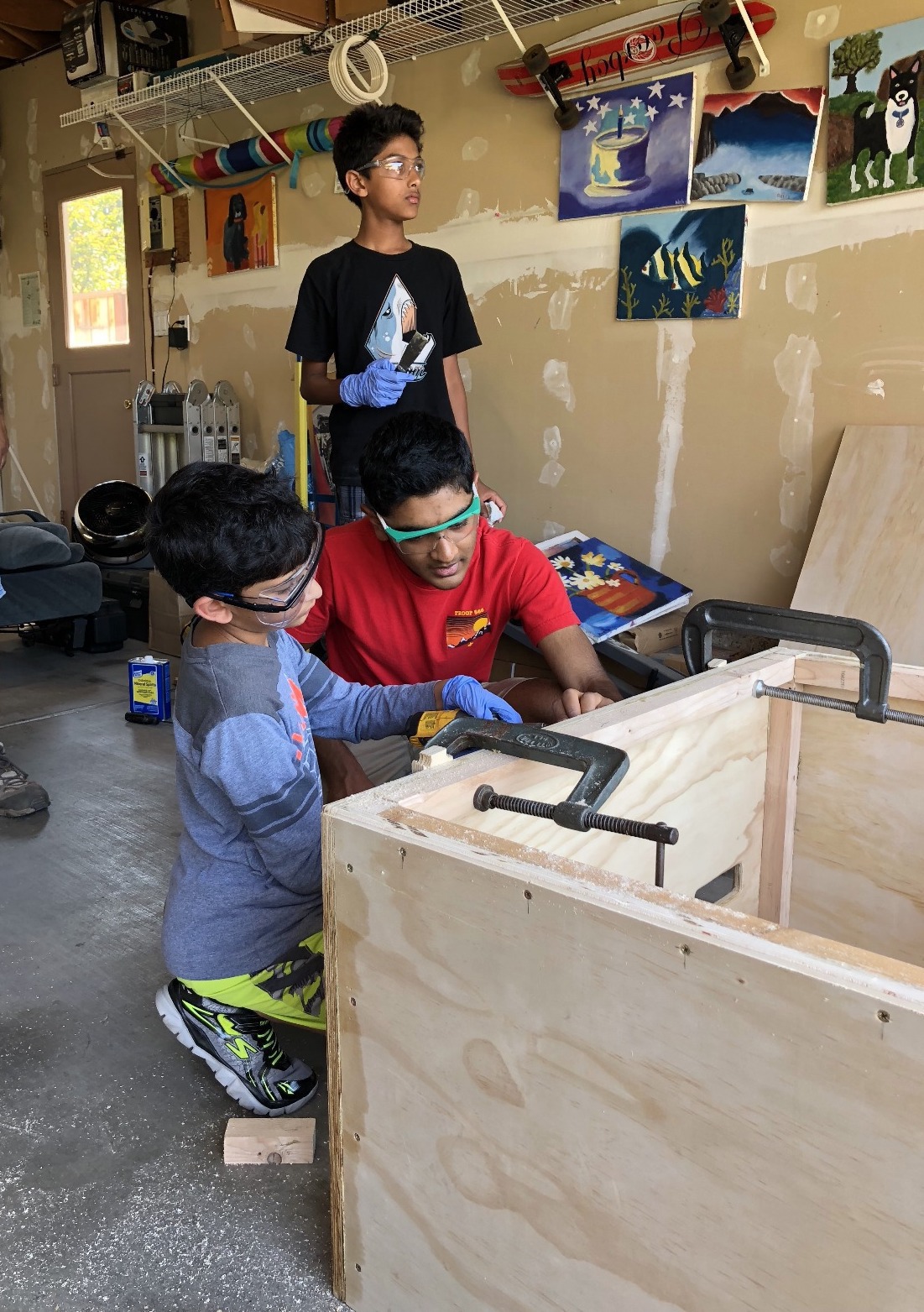 Helping a younger Boy Scout get a screw started.